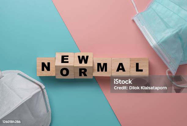 Flat Lay Of Flipping Wooden Block Cubes For New Normal Wording With Surgical Mask The World Is Changing To Balance It Into New Normal Include Business Economy Environment And Health Stock Photo - Download Image Now