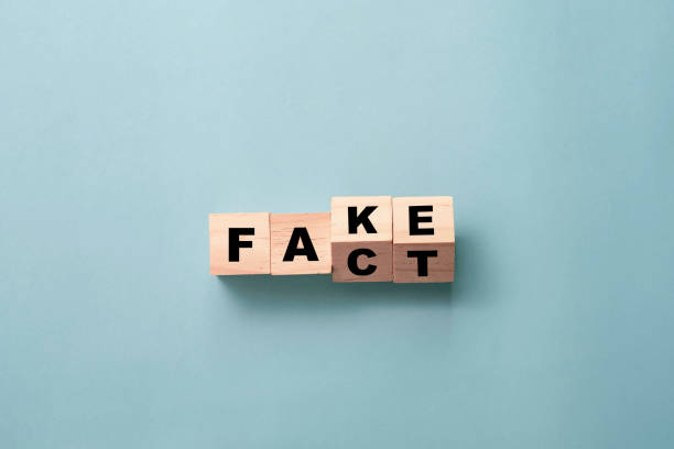 flipping wooden cubes block for change wording from "fake" to "fact". - information equipment imagens e fotografias de stock