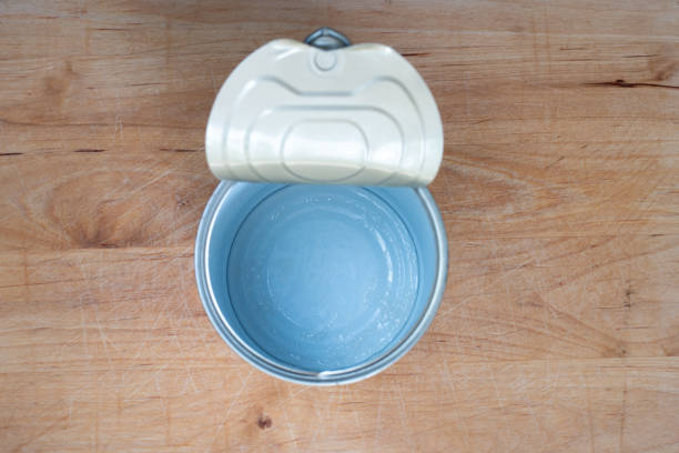 Empty opened can of beans top view set on a wooden kitchen board