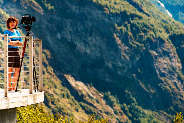 istock Tourist with camera on tripod in Norway nature 1260192438