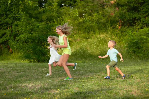 istock Children Running in Summer Meadow 1260198550
