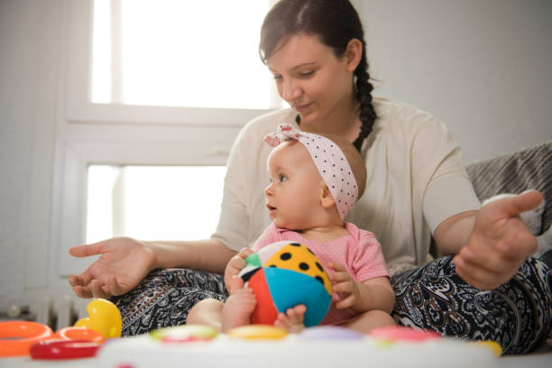 istock Mother and daughter playing on the bed 1260199064