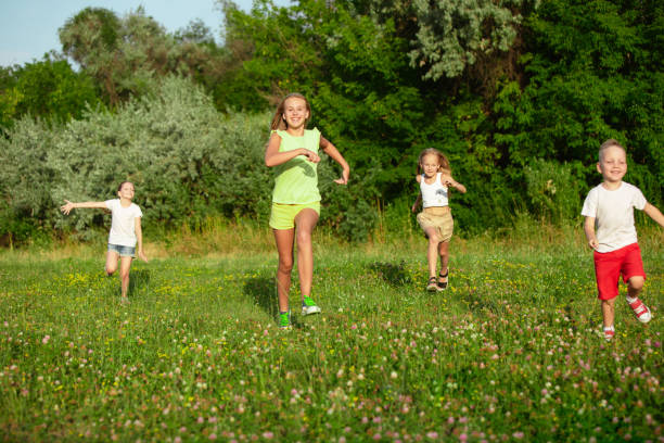 istock Children Running in Summer Meadow 1260199079