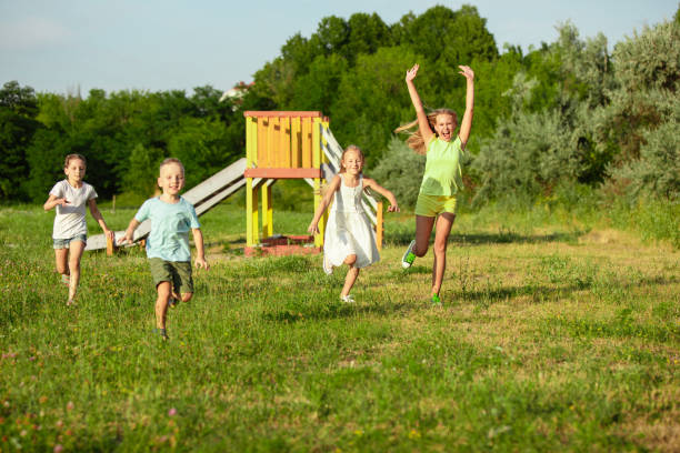 istock Children Running in Summer Meadow 1260199101