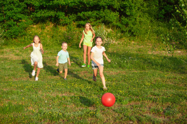 istock Children Running in Summer Meadow 1260199119