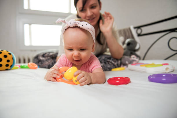 istock Mother looks at the child as he plays 1260201228