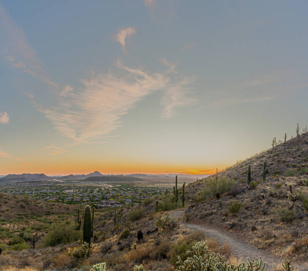 istock A desert trail on a mountain leading to a sunset over a valley in Phoenix 1260201793