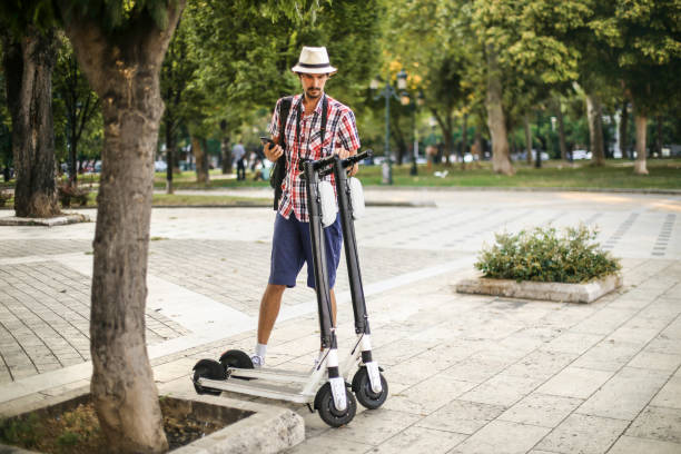 istock Young man setting up an electric scooter 1260203957