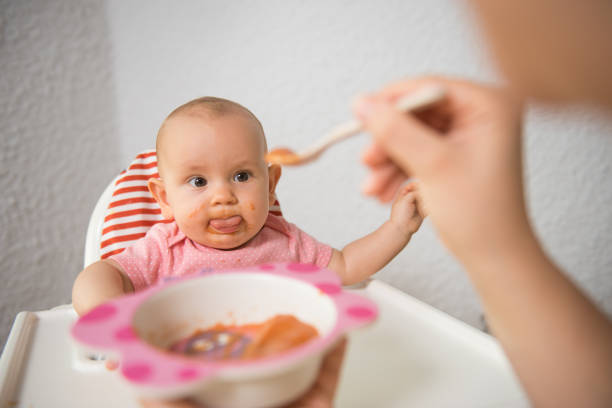 istock A Little baby eating her dinner and making a mess 1260206619