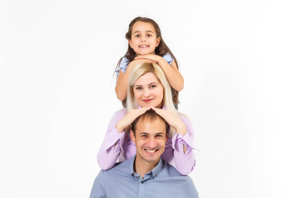 istock Happy young family with pretty child posing on white background 1260208400