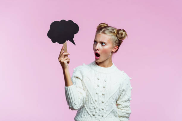 Mid adult women looking at camera with a shock expression, studio shot, white background