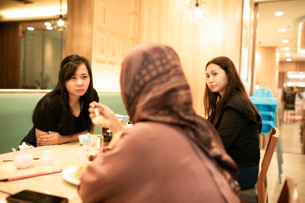 istock happy asian friends having dinner together 1260229071
