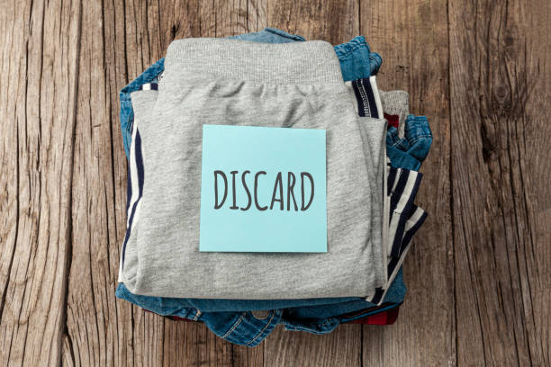 istock Stack of old clothes to discard (declutter) or donate. Recycling fabric cotton 1260237540