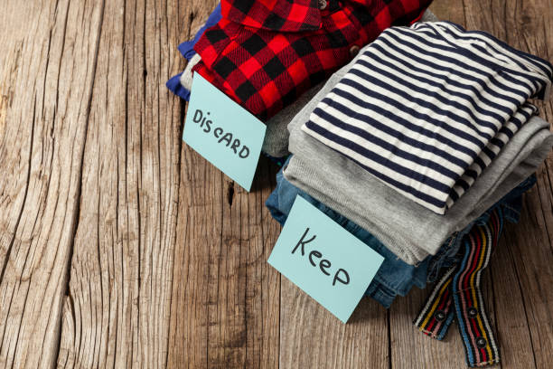 Stack of old clothes to discard (declutter) or keep. Recycle clothes, eco cotton