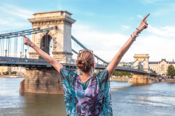 istock Happy woman arms raised at Budapest, Hungary 1260246331