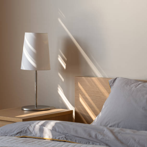 istock Simple lamp on wooden bedside table 1260252951