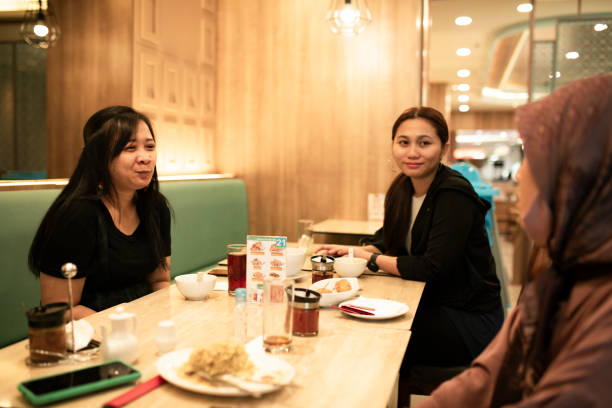 istock happy asian friends having dinner together 1260260020