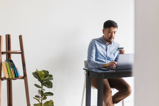 istock Man uses credit card to make online purchase 1260275594