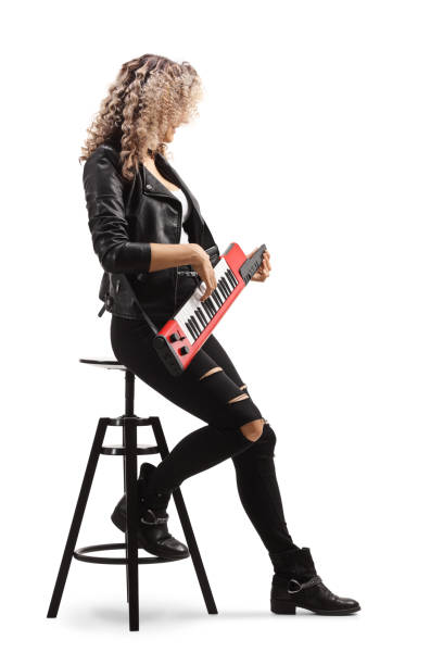 istock Woman sitting on a chair and playing a keytar synthesizer 1260296216