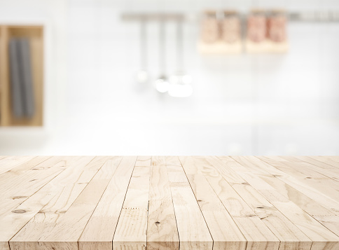 Wood table top on blur kitchen counter (room)background.For montage product display or design key visual layout.