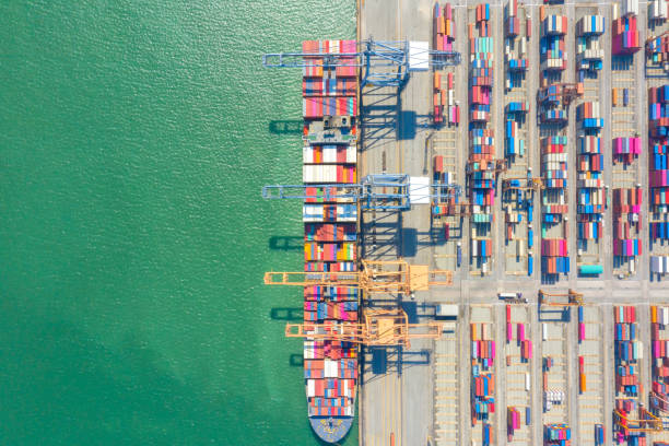 istock Container , container ship in export and import business and logistics. Shipping cargo to harbor by crane. Water transport International. Aerial view and top view. 1260348362