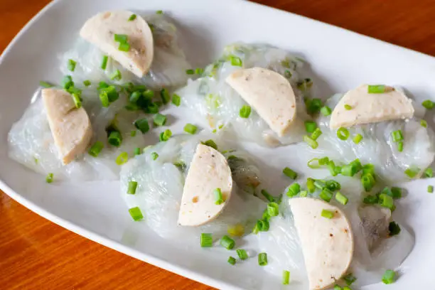 Bánh cun, Vietnamese steamed rice skin dumpling topping with Asian pork sausage. serving on white plate