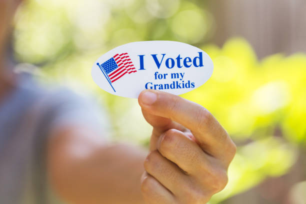 istock Hand holding I voted for my grandkids sticker 1260369638