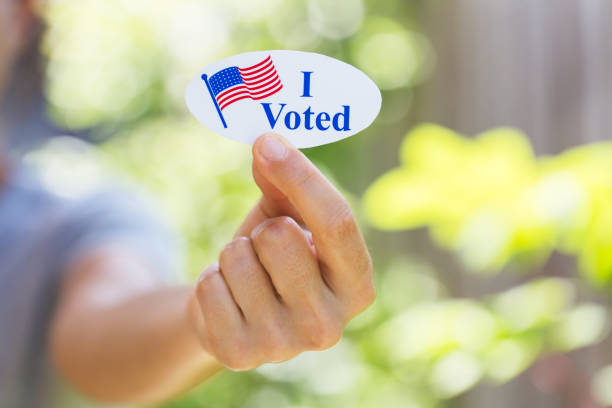 istock Hand holding I voted sticker 1260370271