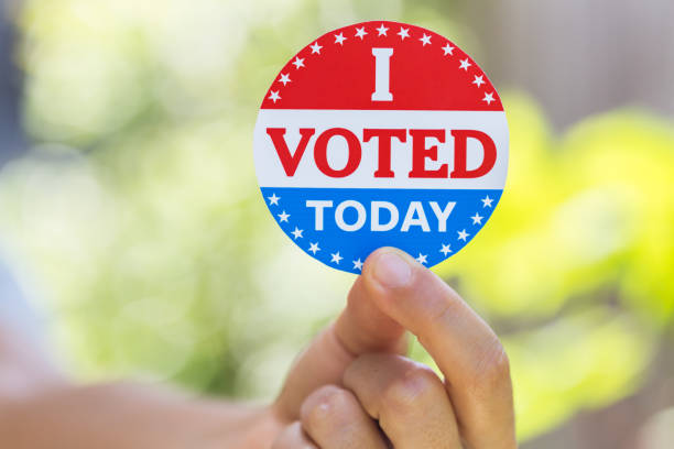 istock Hand holding I voted today sticker 1260371809