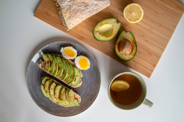 istock Avocado and egg sandwich on a wooden background. Fresh organic vegetables, eggs and bread. 1260381557