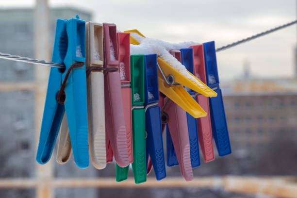 Snow-covered clothespins outside in winter, low temperatures
