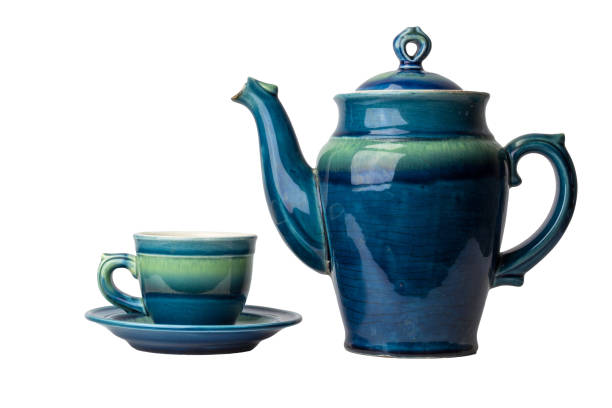 istock Blue ceramic hot tea pot and cup on plate isolated on white background 1260391374