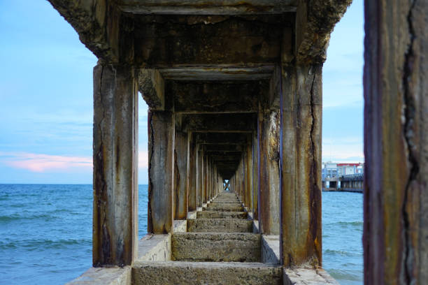 istock Tunnel under the old pier bridge rust, beautiful and stylish structure in the eastern sea of Thailand 1260397691