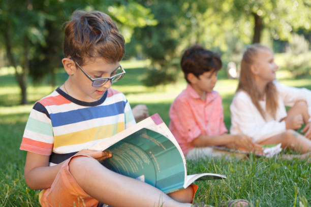 istock Kids studying outdoors in the park 1260415099
