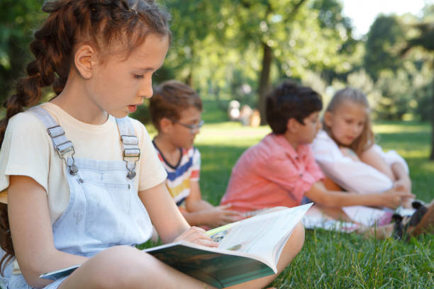 istock Kids studying outdoors in the park 1260416243