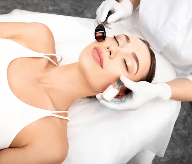 istock Beautician doing skin treatment using a microneedle derma roller. Woman getting procedure skincare, with mezzo skin roller 1260416769