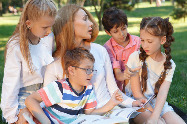 istock Kids studying outdoors in the park 1260418463