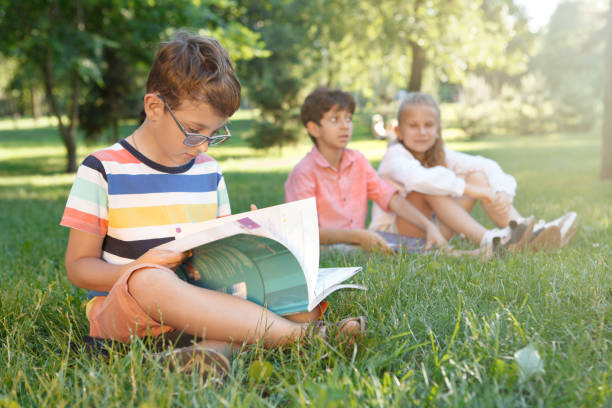 istock Kids studying outdoors in the park 1260418470