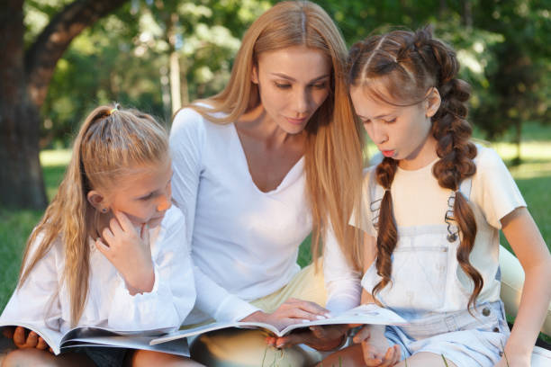 istock Kids studying outdoors in the park 1260421713