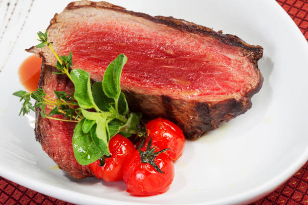 istock Medium Grilled bbq steaks and savory tomato sauce. As backdrop for menus, cookbooks, advertisements and other culinary projects 1260424927