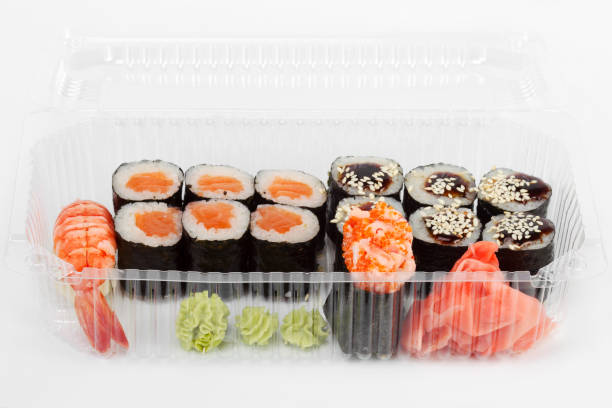 istock Salmon rolls in plastic container. Sushi delivery. As backdrop for menus, cookbooks, advertisements and other culinary projects 1260426574