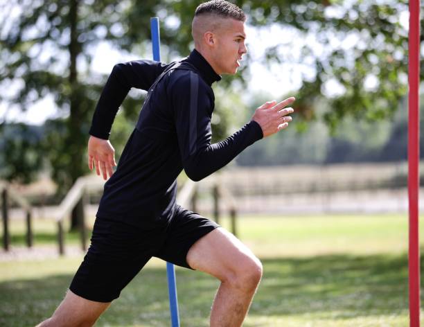 A young man , Lawson, football training. A young man training .a football training session. Sprinting and exercising in a field. Lots of running. Wearing a black tracksuit top and black shorts . A very hot sunny day. June 2020 Southampton . United Kingdom. soccer team captain stock pictures, royalty-free photos & images