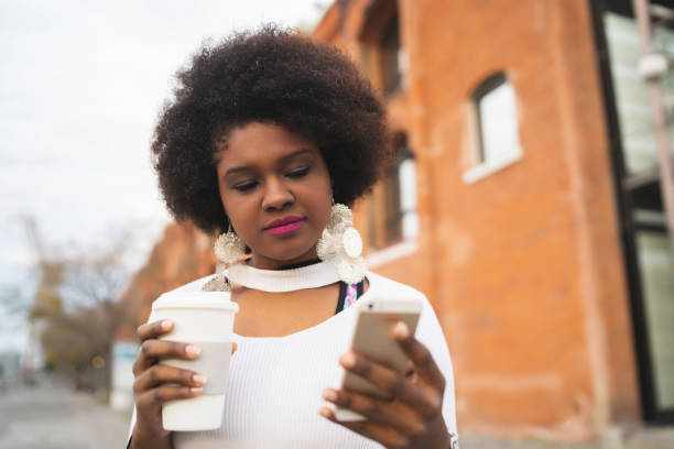 istock Afro latin woman using her phone. 1260444677
