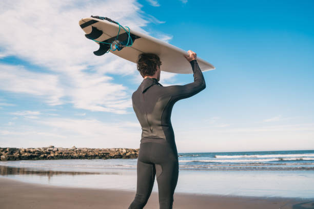 istock Young surfer holding up his surfboard. 1260445778