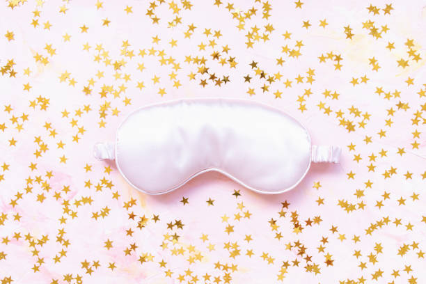 istock Pink satin eye sleeping mask and golden stars 1260448468