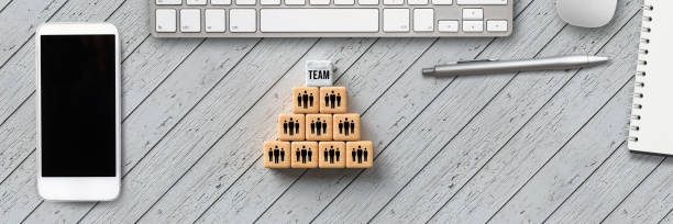 stacked cubes with people symbols, a smartphone, notepad and computer keyboard - faq connection computer keyboard learning imagens e fotografias de stock