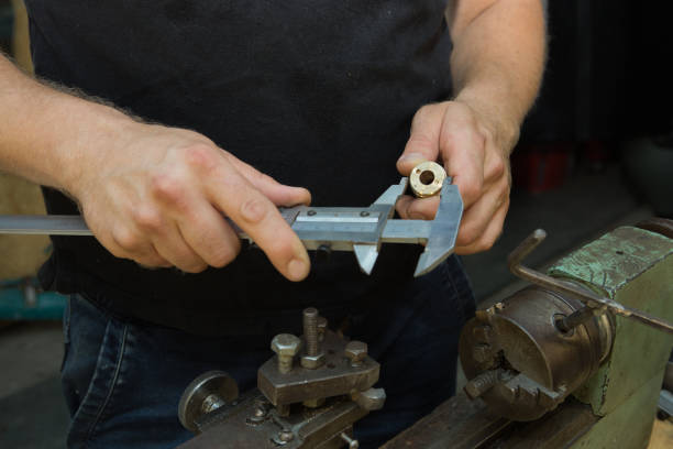 istock Working on a lathe. Preparing and setting up the machine. Hands of the master. 1260449553
