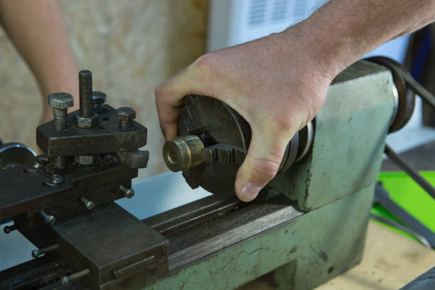istock Working on a lathe. The machine is ready for work. The wizard checks that the settings are correct. 1260451130
