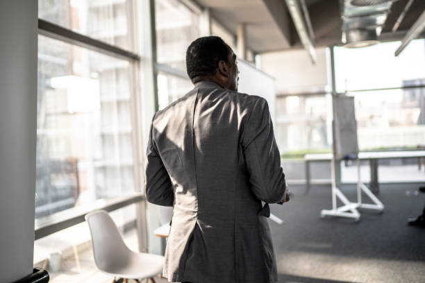 istock Rear view of a businessman doing a presentation to a team 1260466719