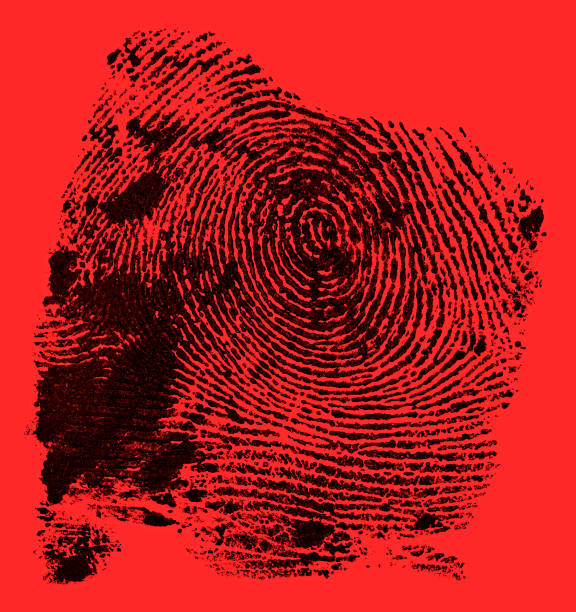 istock Black ink fingerprint on red background. Human fingerprint. Criminal style. 1260468299